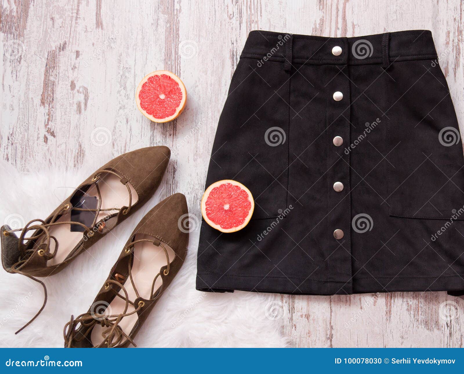 Black Suede Skirt, Brown Suede Shoes, Cut Grapefruit Halves. Wooden ...