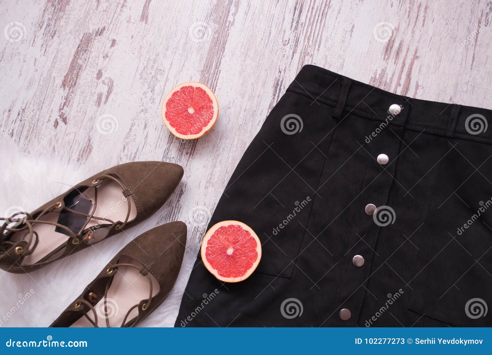 Black Suede Skirt, Brown Suede Shoes, Cut Grapefruit Halves. Wooden ...