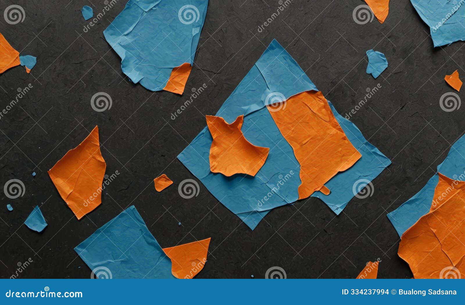 black surface with orange and blue pieces paper