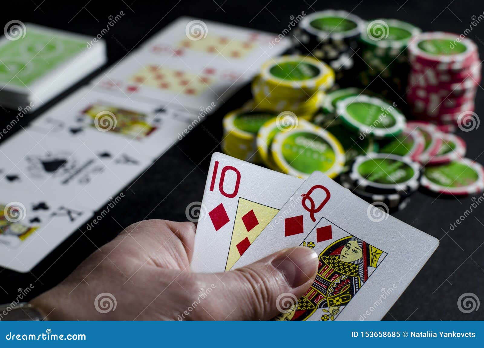 Person looking at their cards in poker