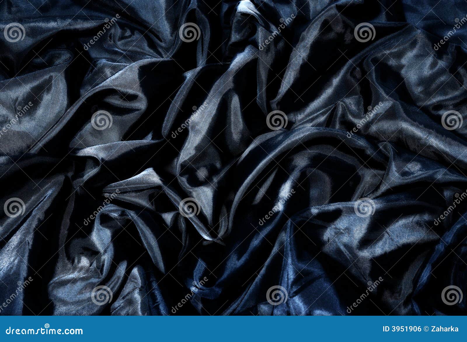 black textile fabric with creases and blue shine