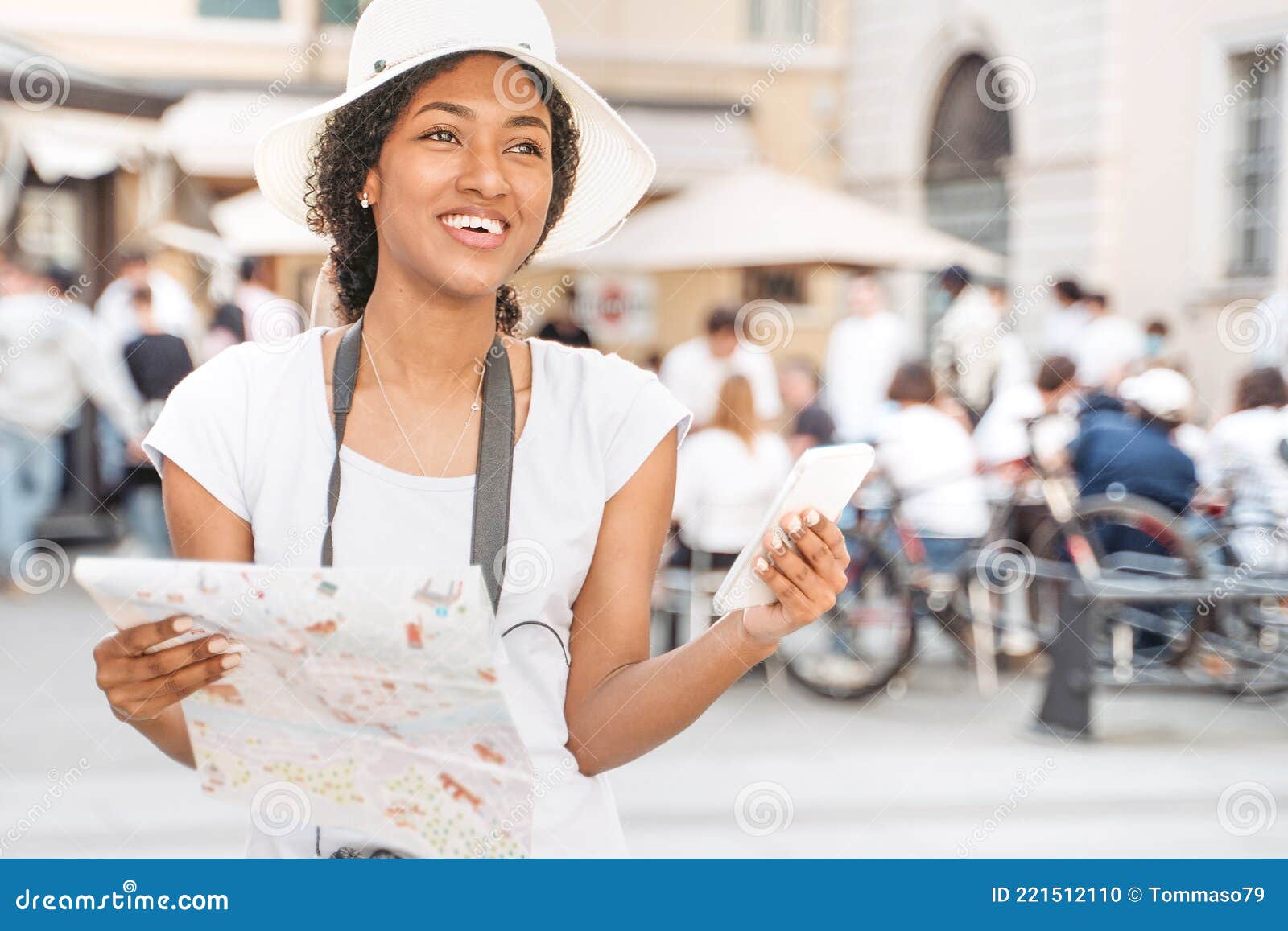 Black Tourist Woman Visiting City Holding a Map and Cell Phone Stock ...