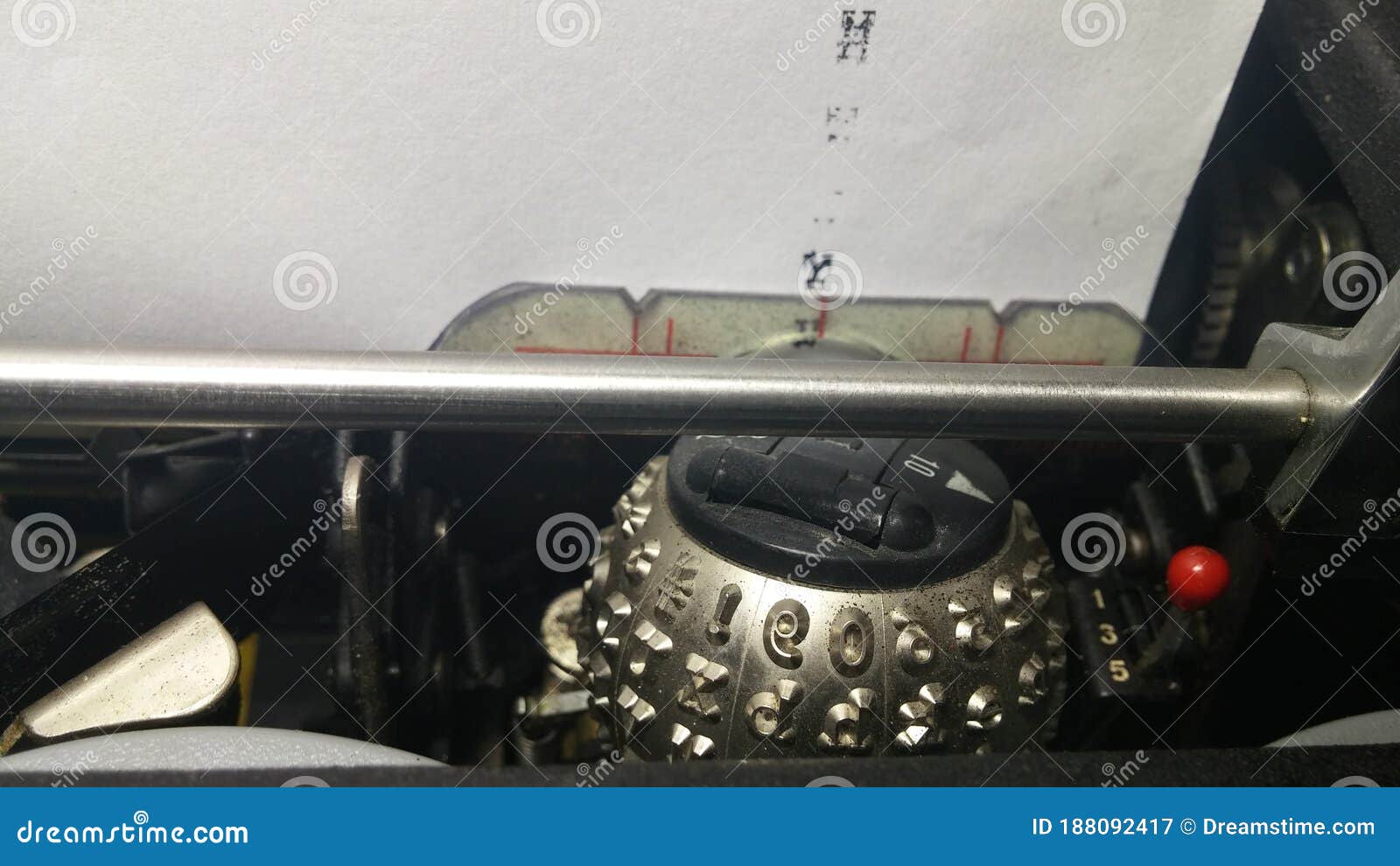 Black Typewriter Head Ball Writing on a Sheet of White Paper with Ink