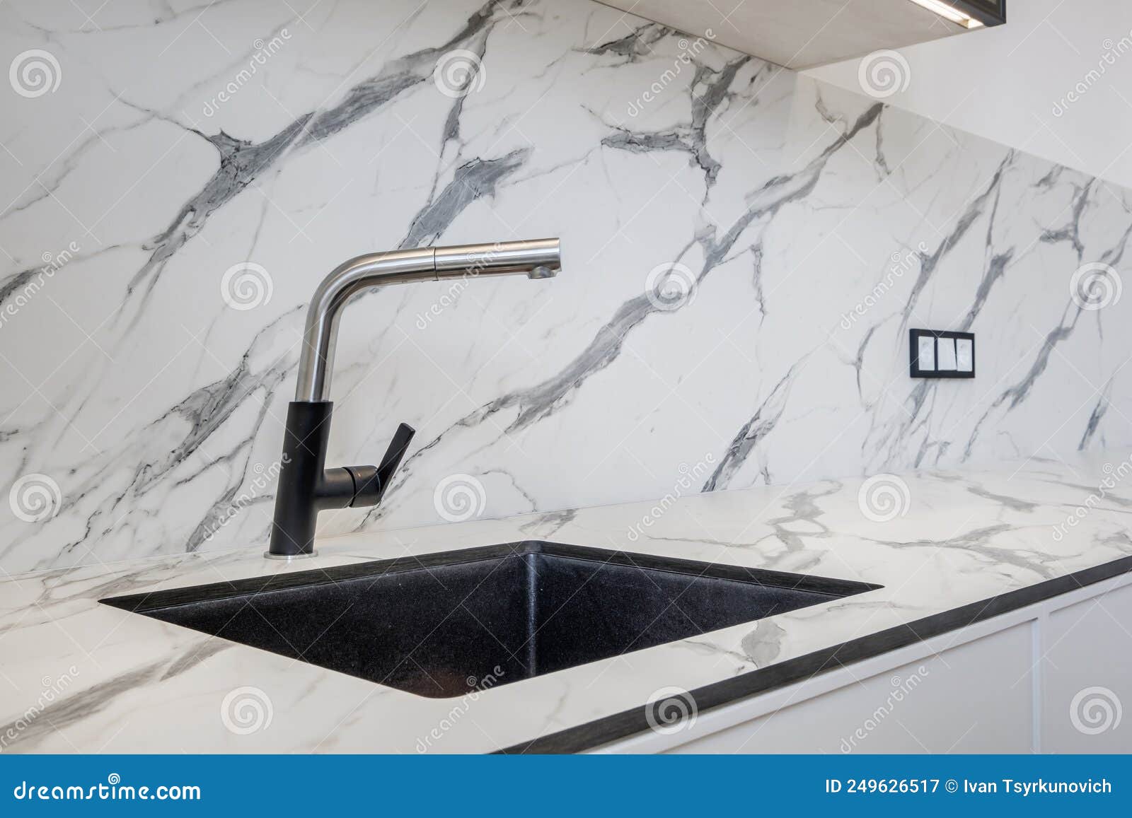 Black Water Tap Sink with Faucet in Expensive Kitchen Stock Image