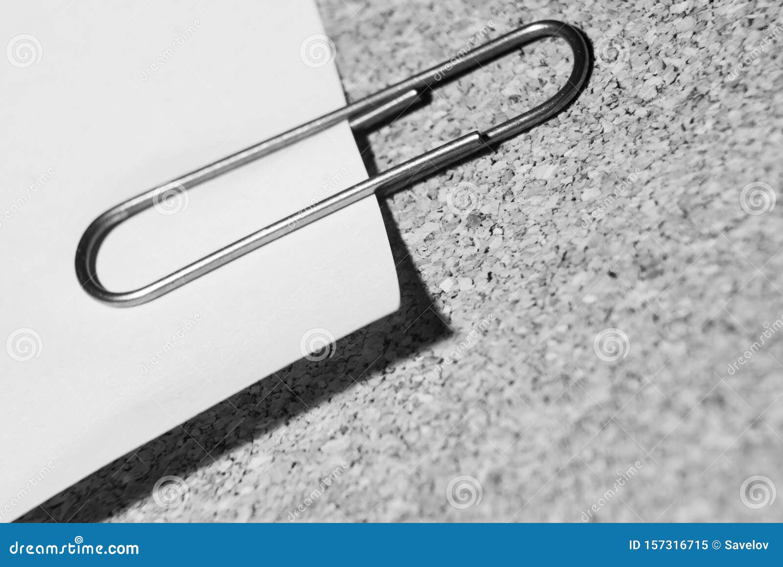 monochrome background with paper and a clip on a note board is macro