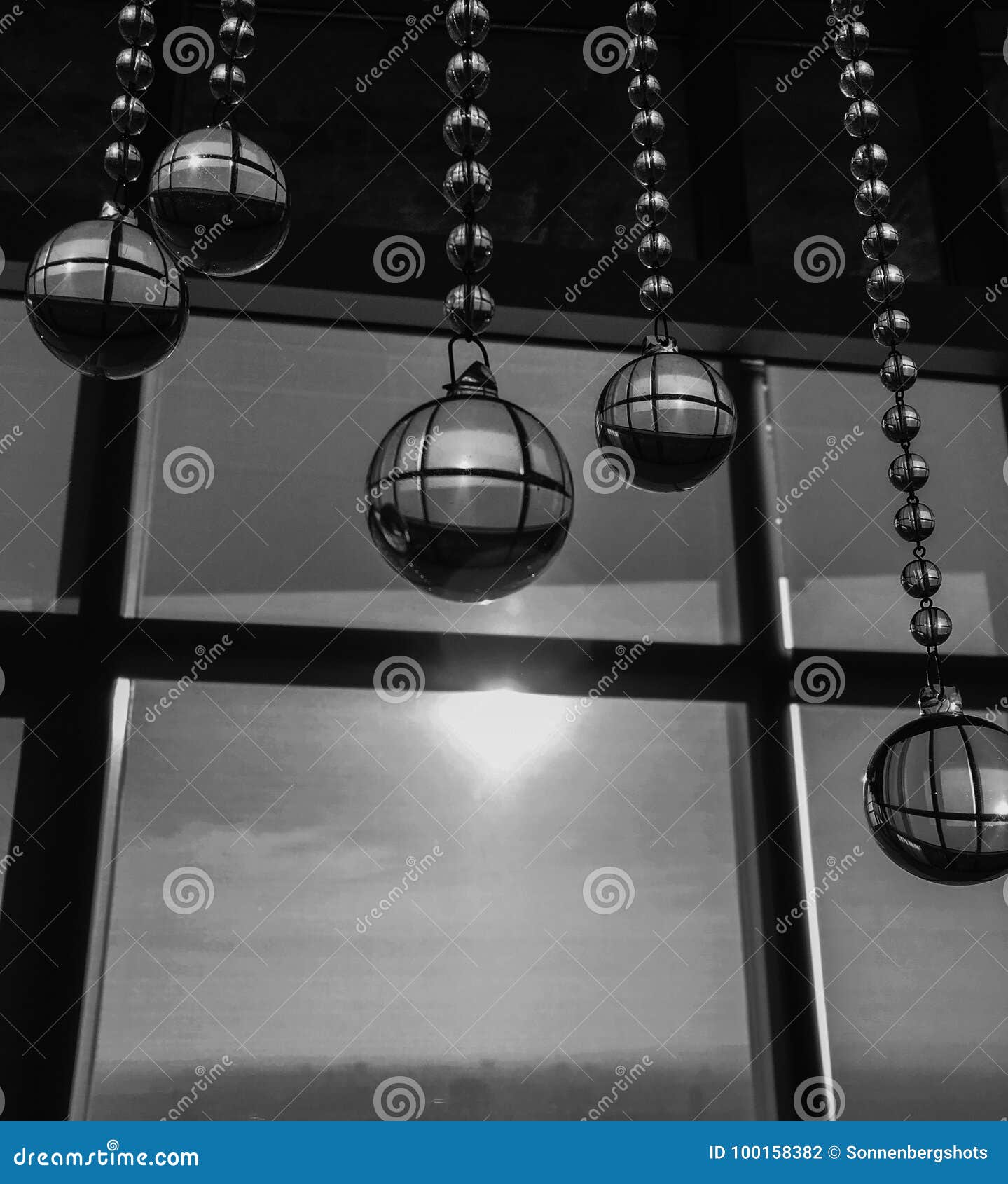 Black And White Of Crystal Balls Hanging From Ceiling In