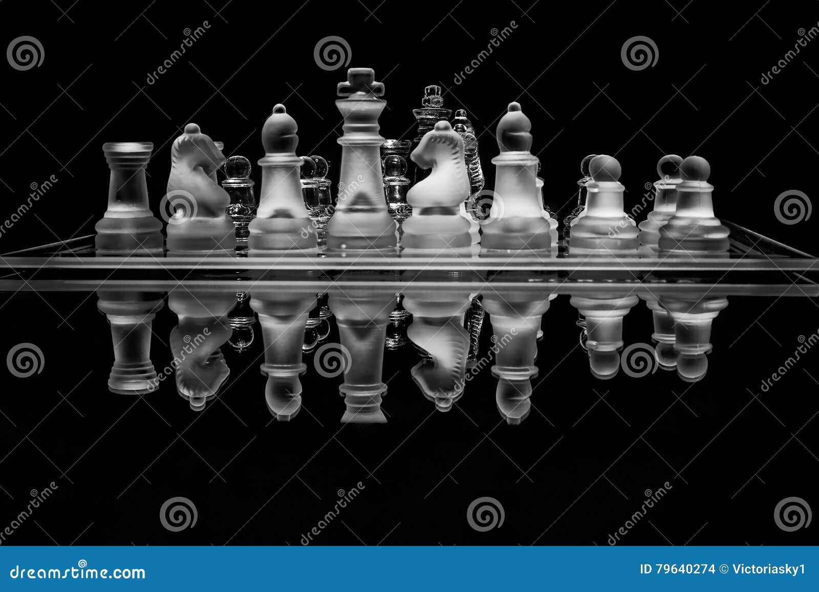 black and white glass chess set with reflection