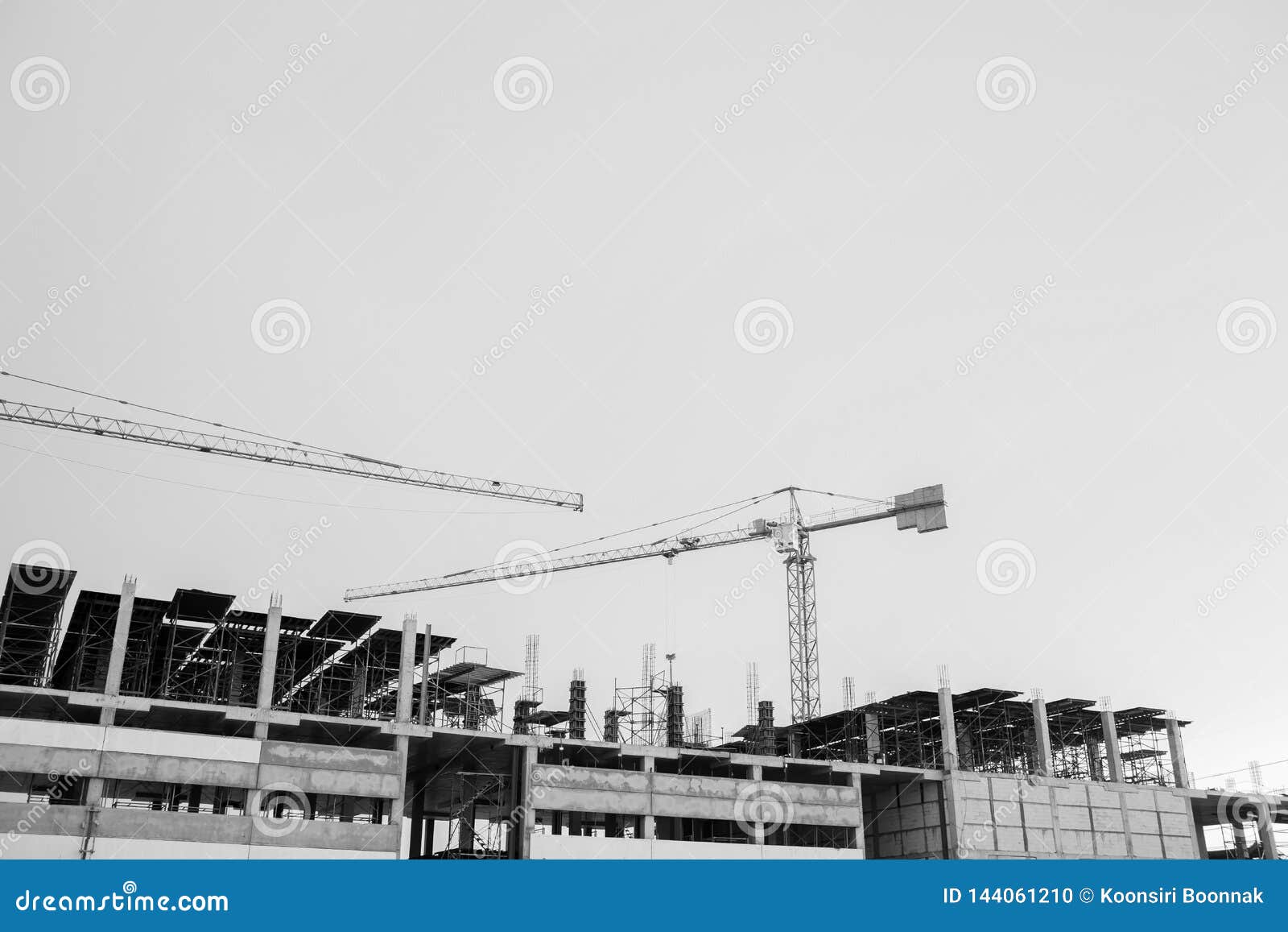 Black and White Image of Building Crane and Buildings Under ...