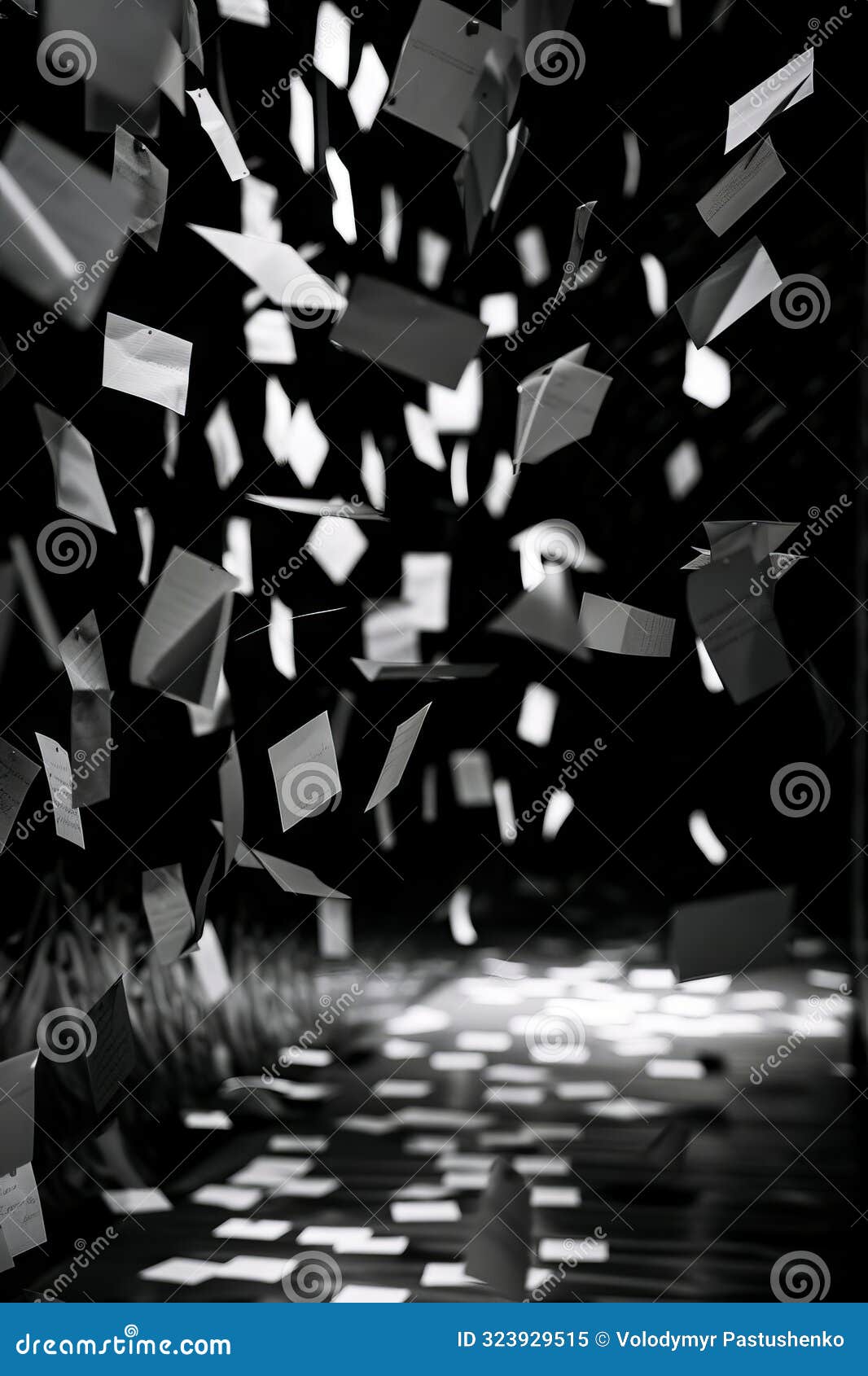 A Black and White Image of Confetti Falling from the Ceiling Stock