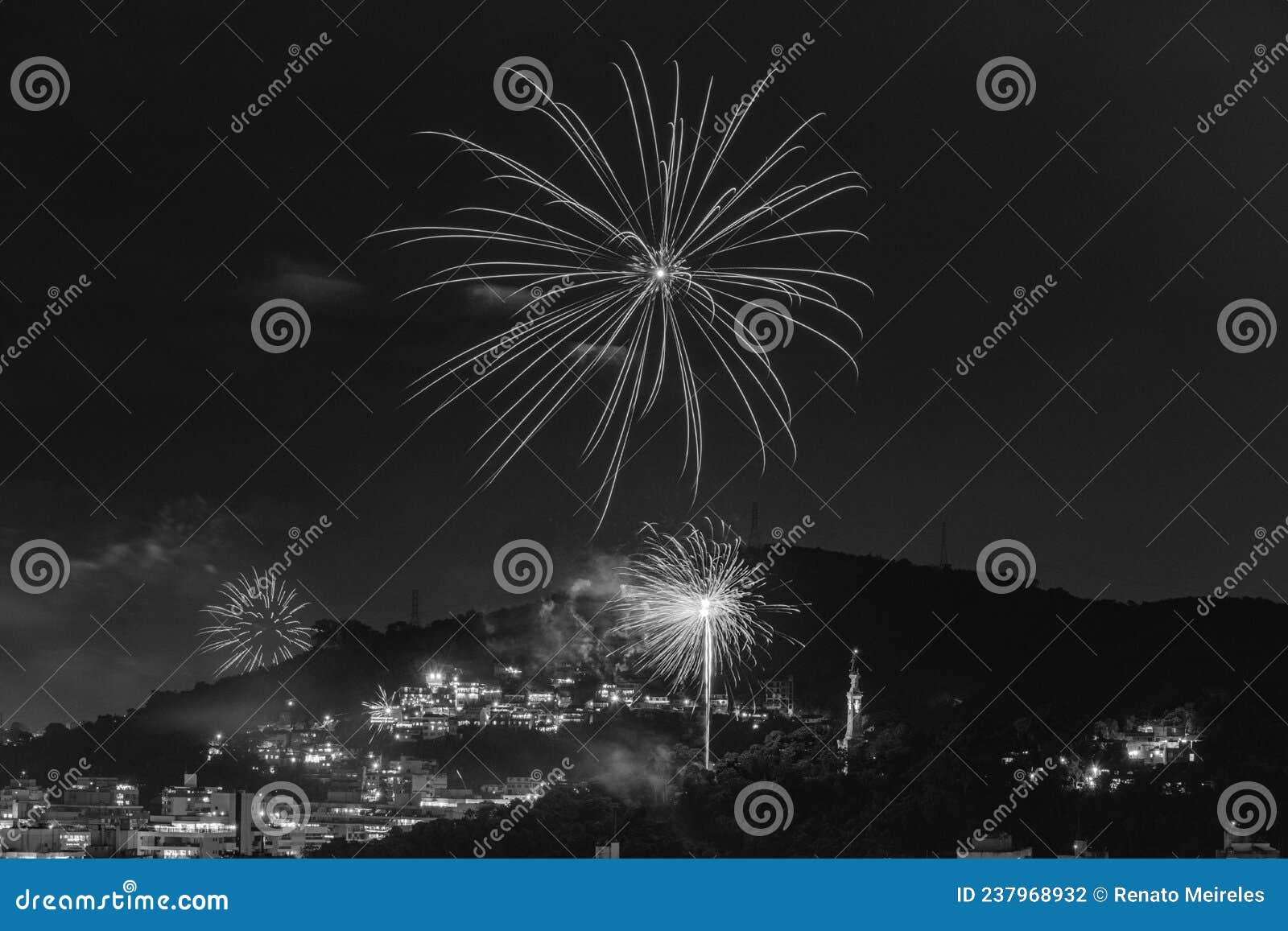 black and white nighttime images with new year`s, rÃÂ©veillon, fireworks exploding in the sky. event held for the 2022 arrival