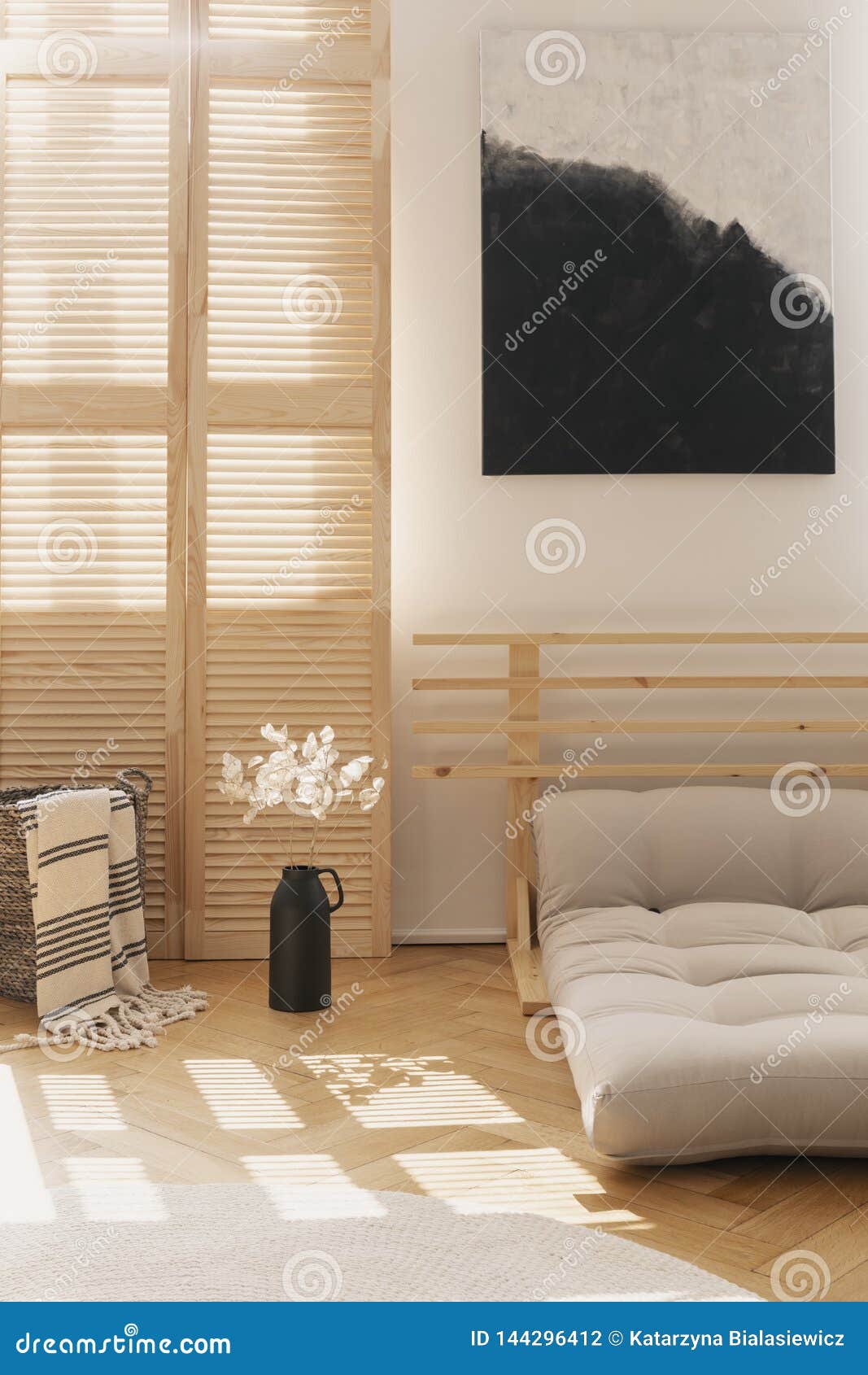 Black And White Painting Above Beige Scandinavian Bed Made