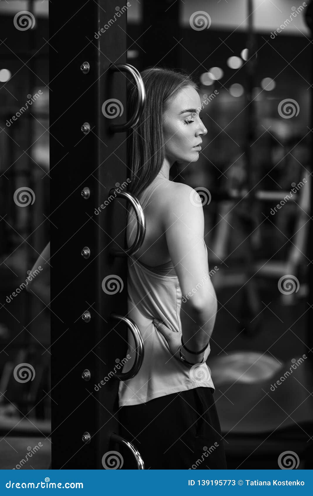 Black And White Photo Of The Beautiful Athletic Girl Dressed In Sporty Clothes Standing With