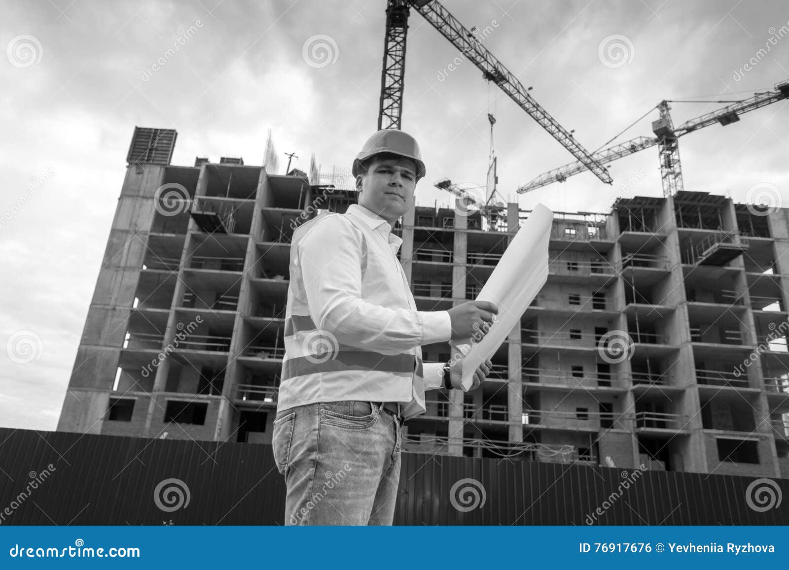 Black and White Portrait of Engineer with Blueprints on Building Stock ...