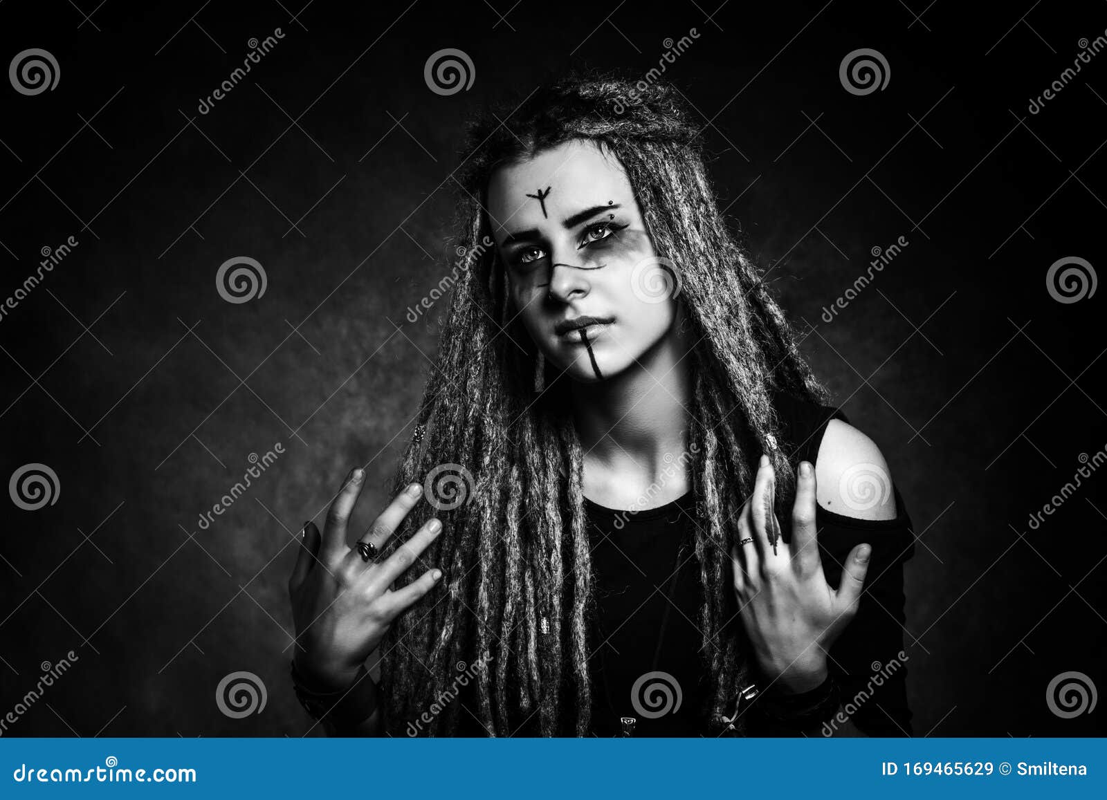 Black and White Portrait of a Young Woman with Dreadlocks Against Dark ...