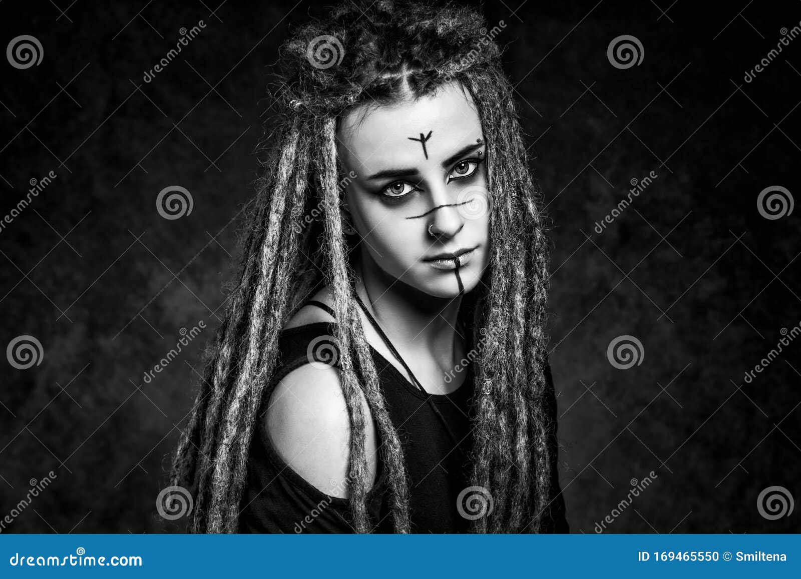 Black and White Portrait of a Young Woman with Dreadlocks Against Dark ...