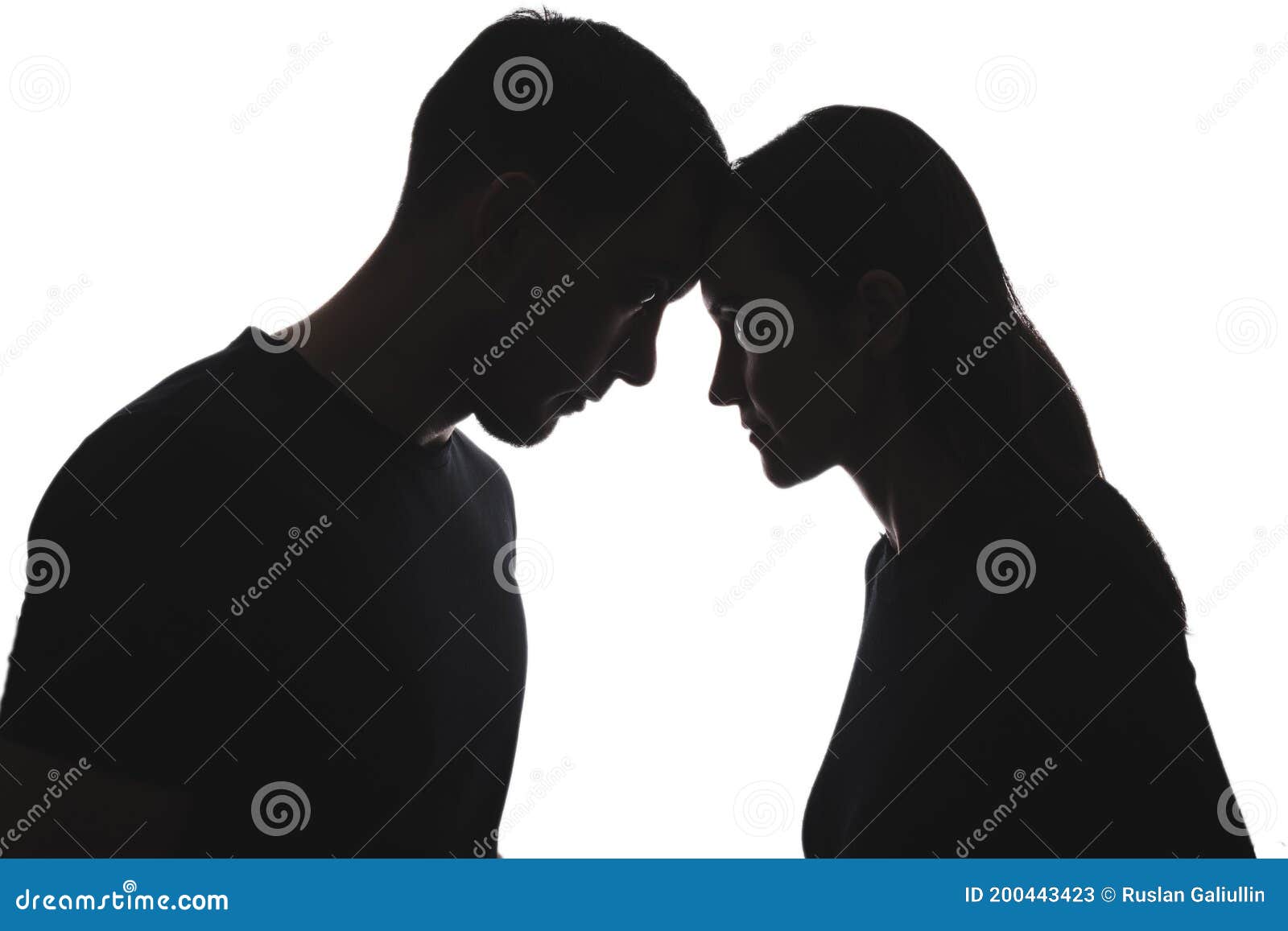 black and white silhouettes of portraits men and women on white background stand opposite each other, touching their foreheads.