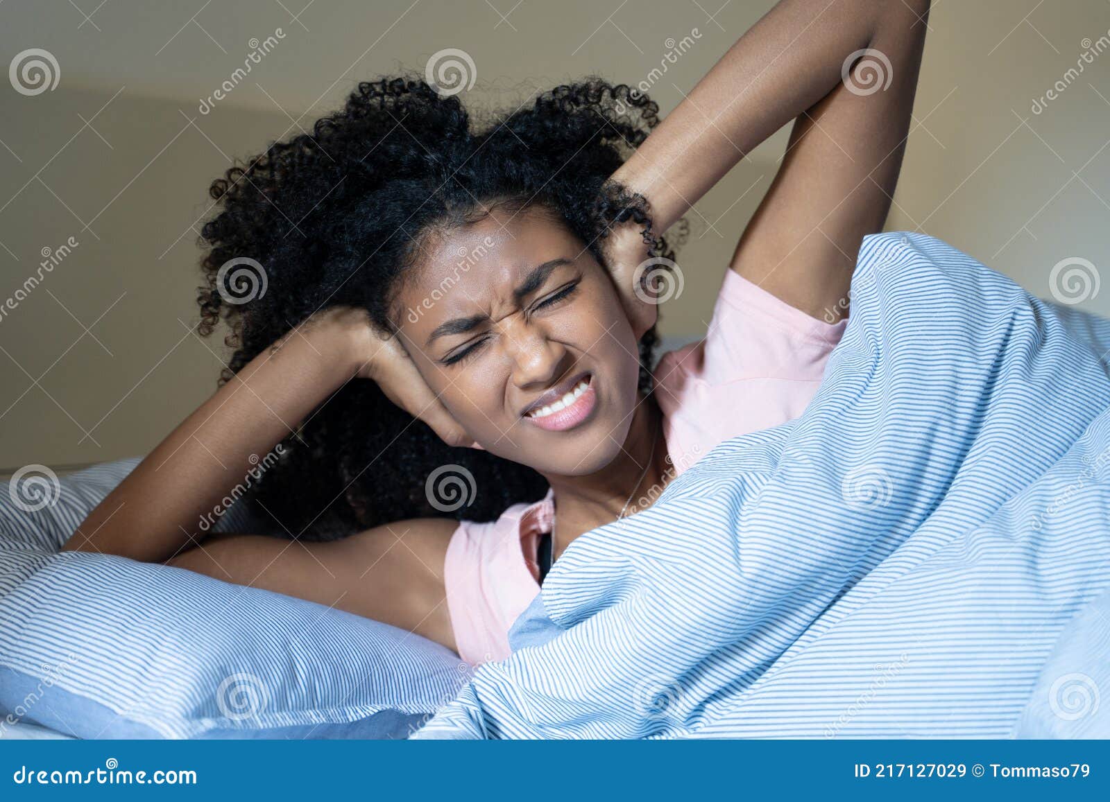 black woman suffering insomnia because of noisy neighbour