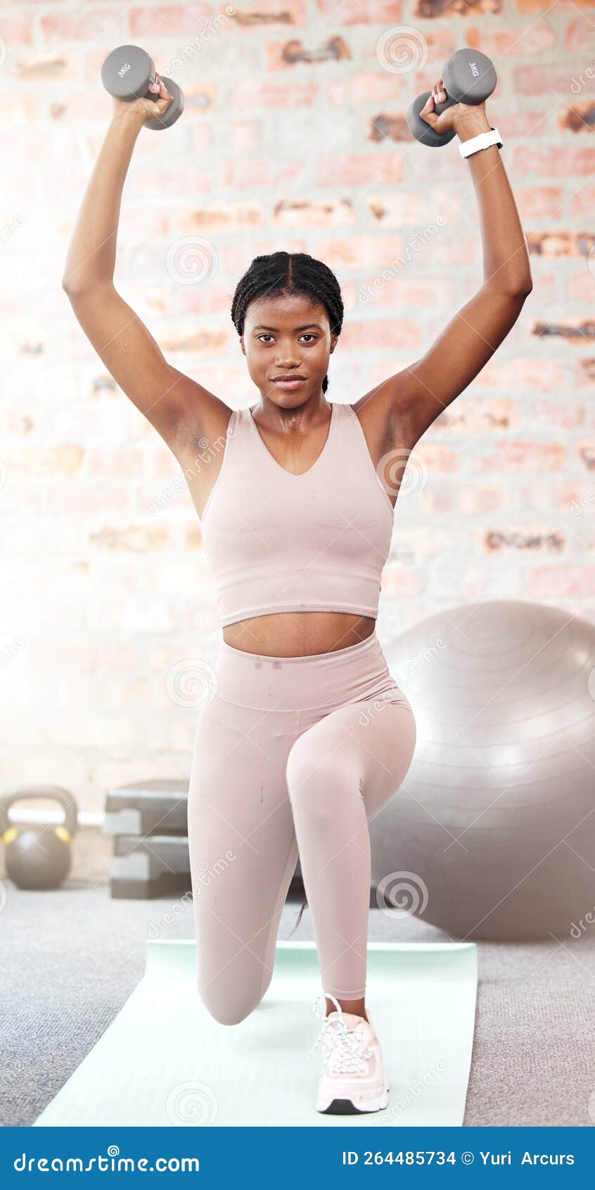 Beautiful healthy happy smiling black asian woman with dumbbell