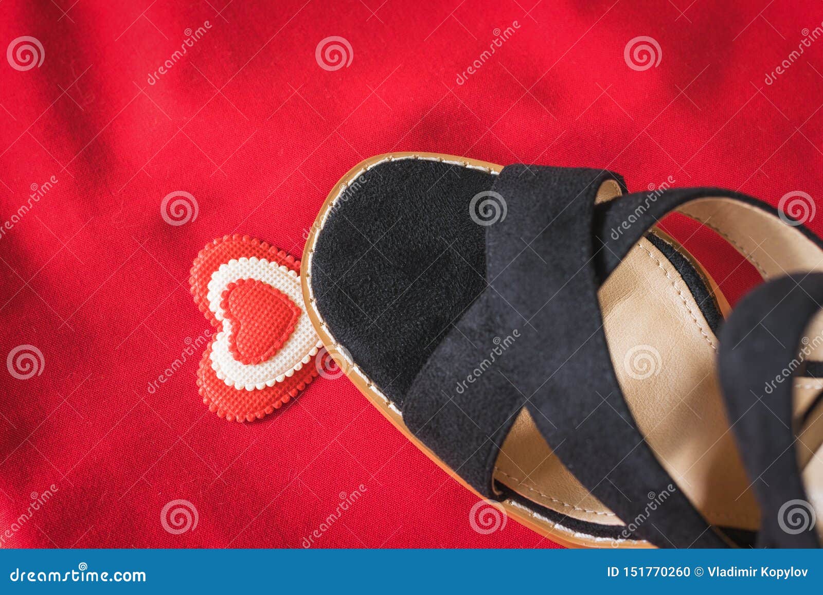 A Black Woman`s Shoe Steps on the Heart on a Red Background. Flat Lay ...