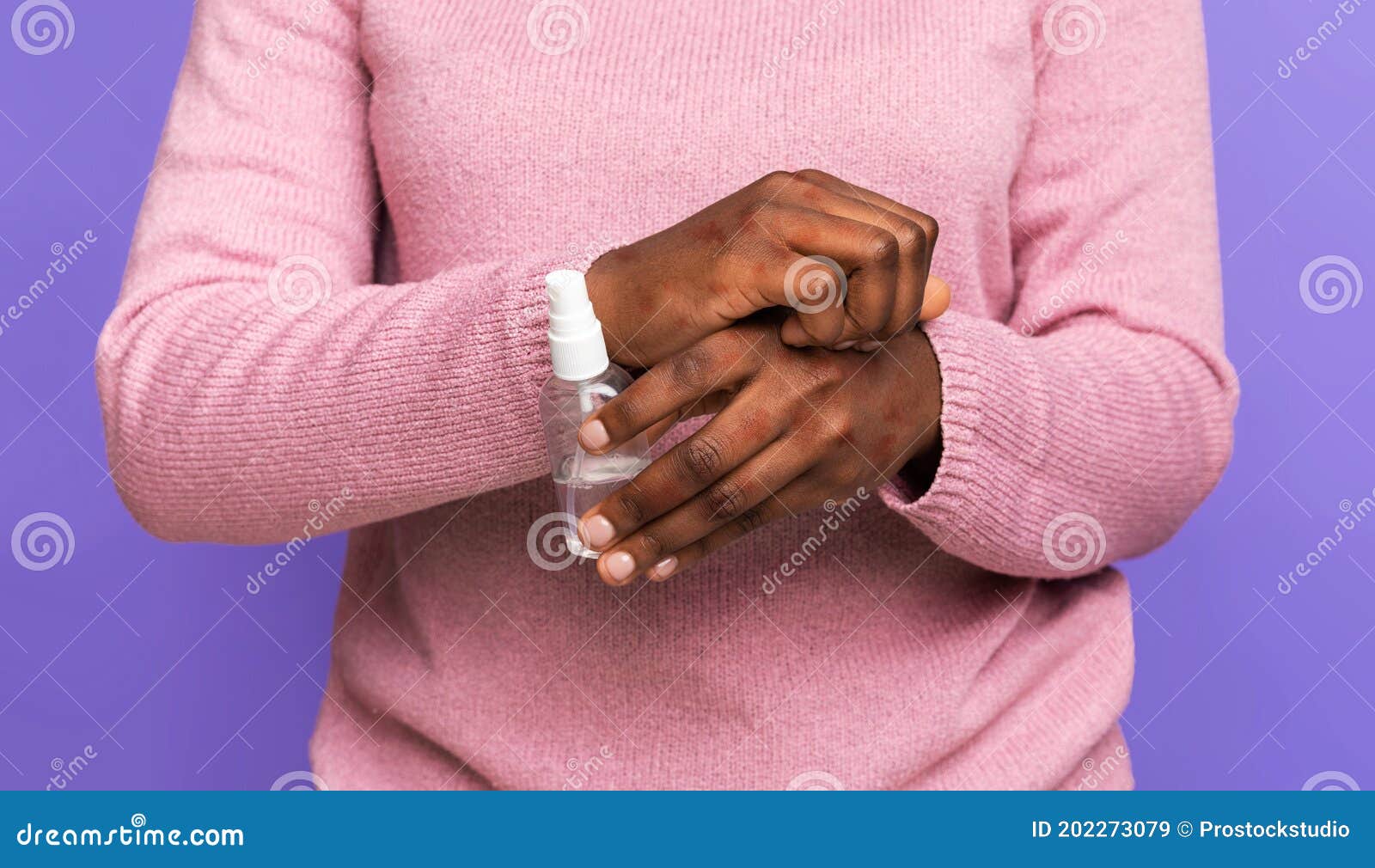 black woman scratching irritated skin with eczema and holding bottle with disinfectant