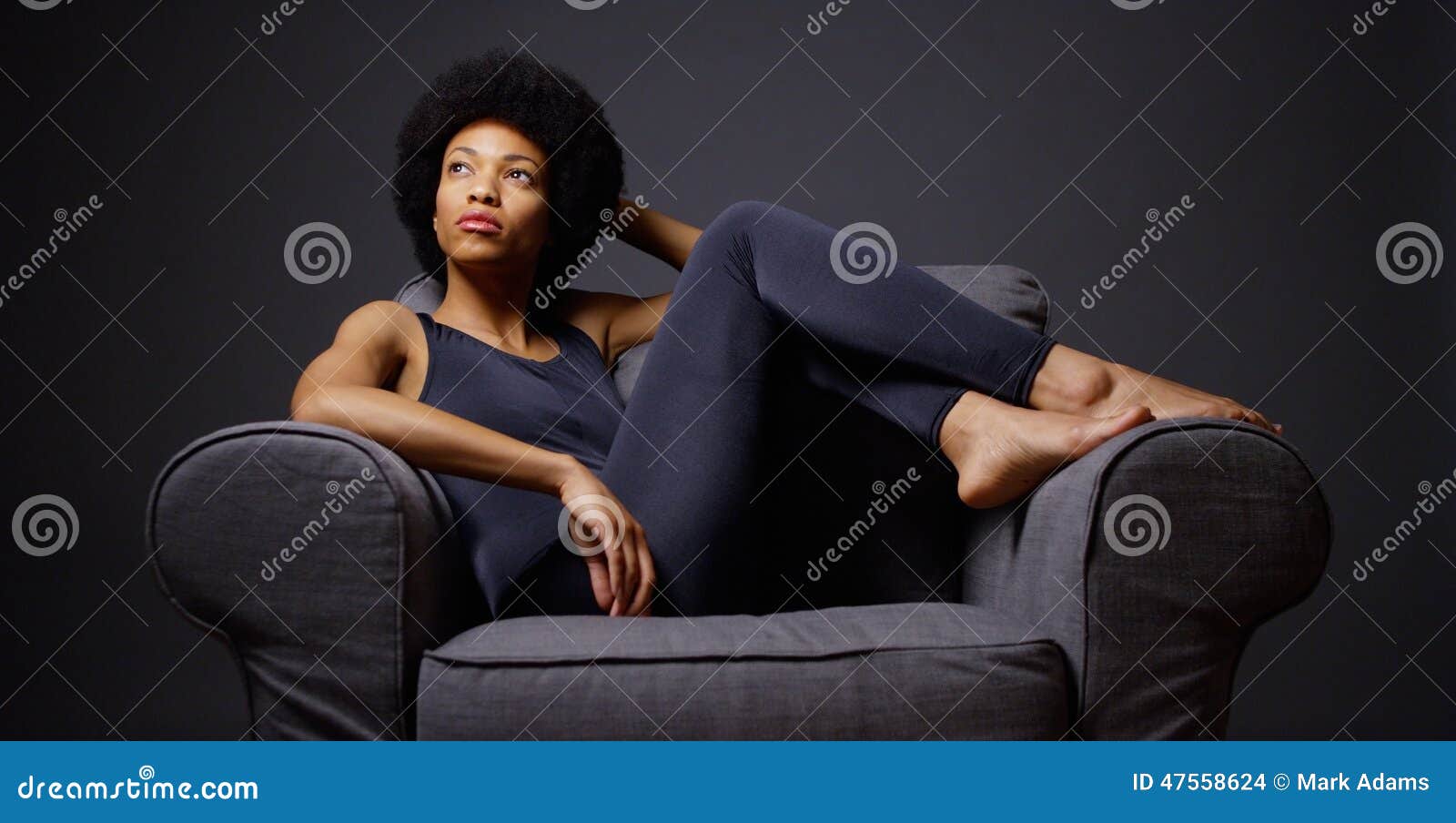 Pensive woman sitting at table in living room while thinking about next chess move. Stock Photo by DC_Studio