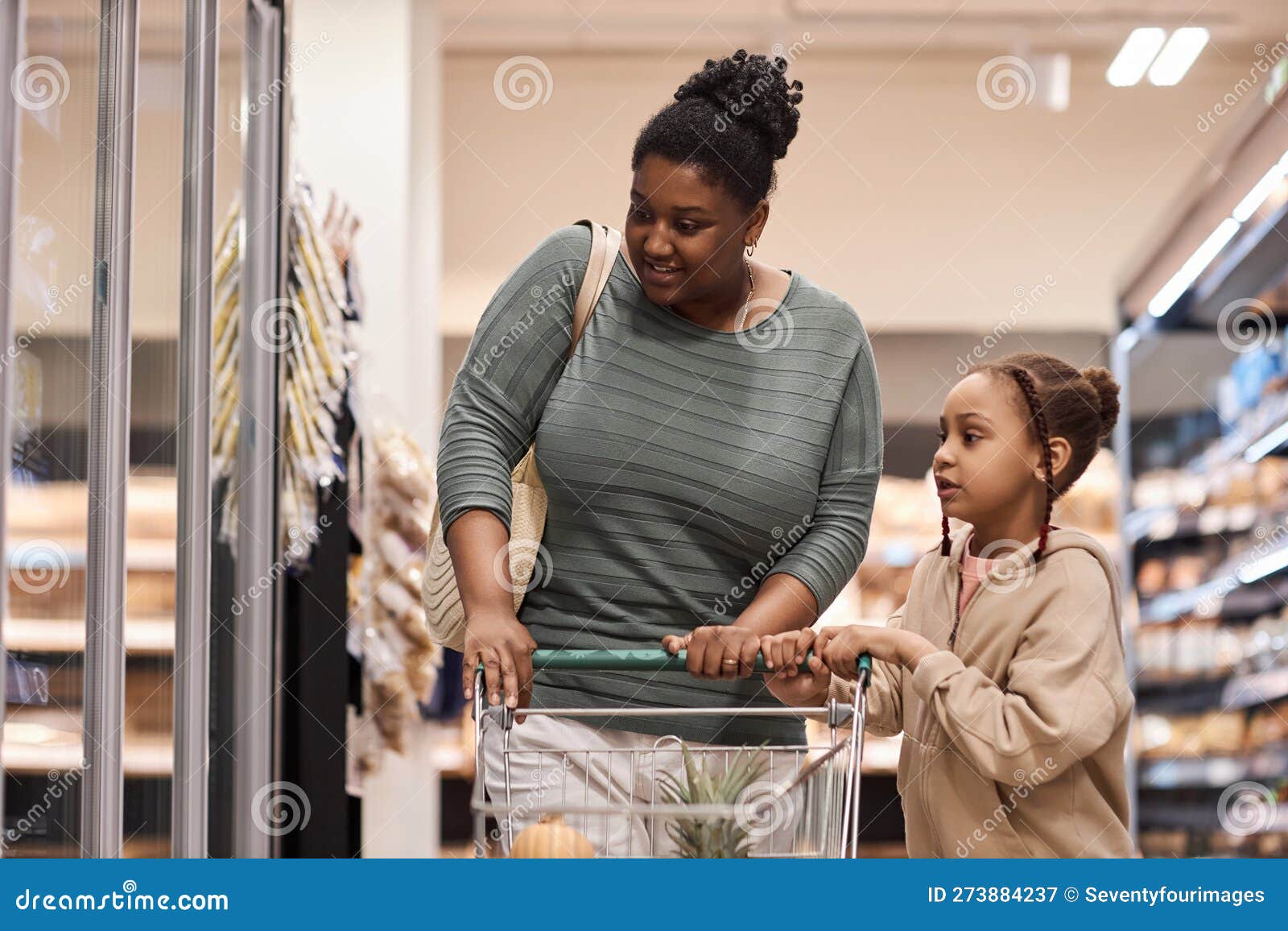 Black Woman in Supermarket Shopping for Groceries with Little Girl ...