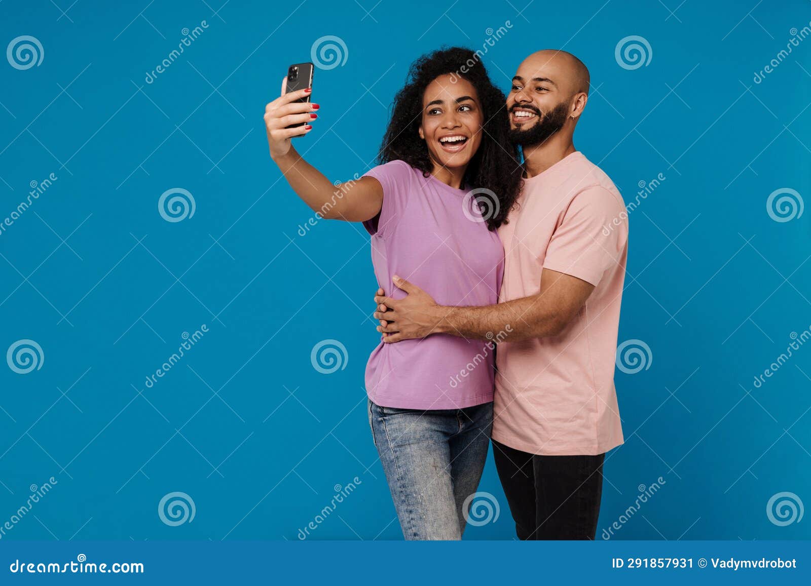 black young man and woman taking selfie photo on cellphone