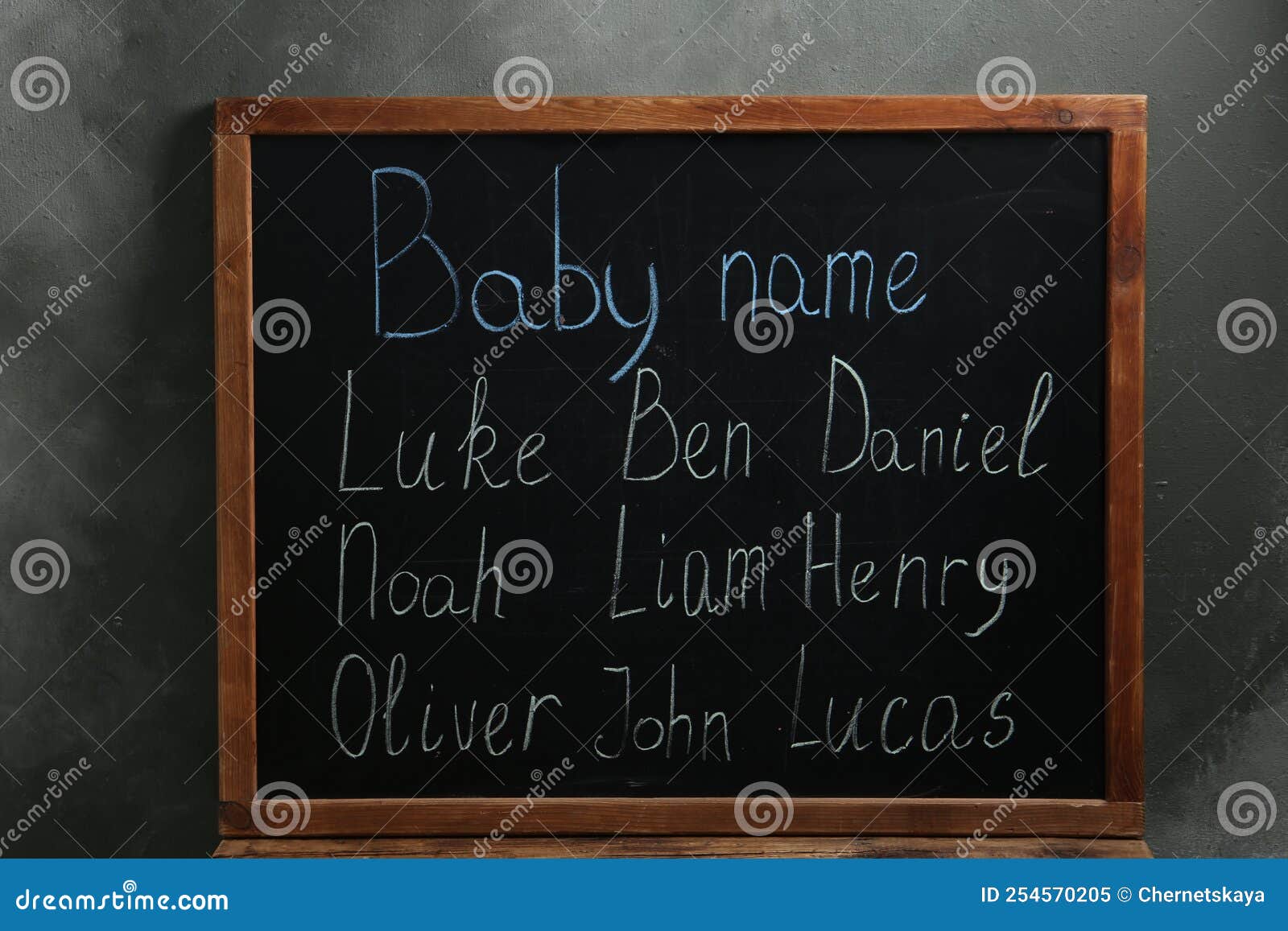 Blackboard with Baby Names Near Dark Wall Stock Image Image of color