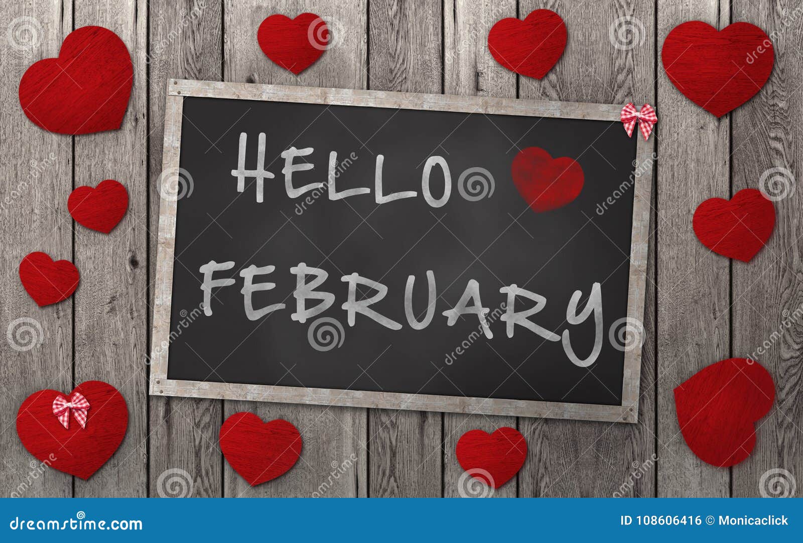 blackboard with words hello february, surrounded by red hearts on weathered wooden background