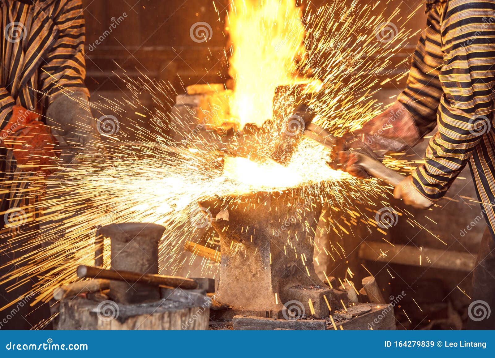 Blacksmith the Molten Metal with a Hammer To Make Keris Stock