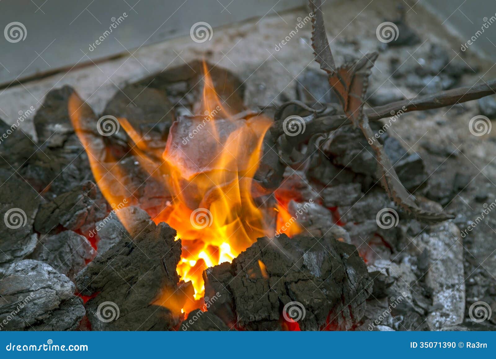 Blacksmith heating up iron stock photo. Image of melting 35071390