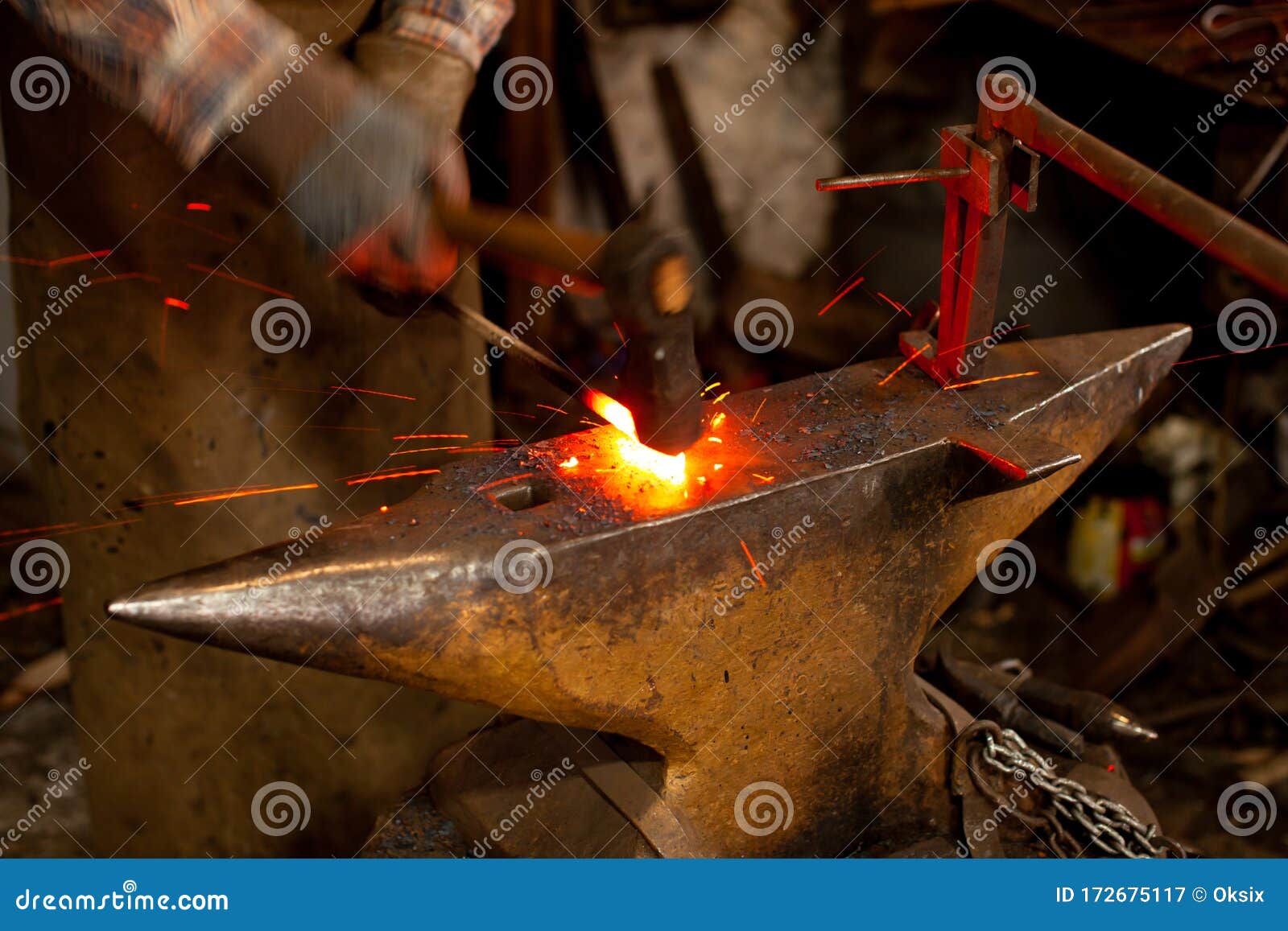 The Blacksmith Manually the Molten Metal on the Anvil in Smithy