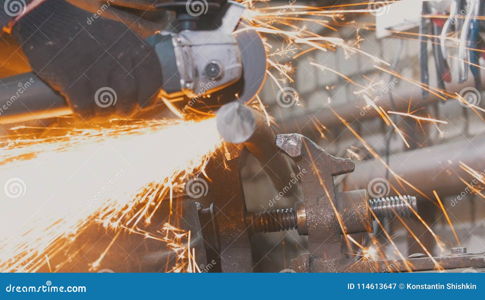 blacksmith worker in forg making detail with circular saw