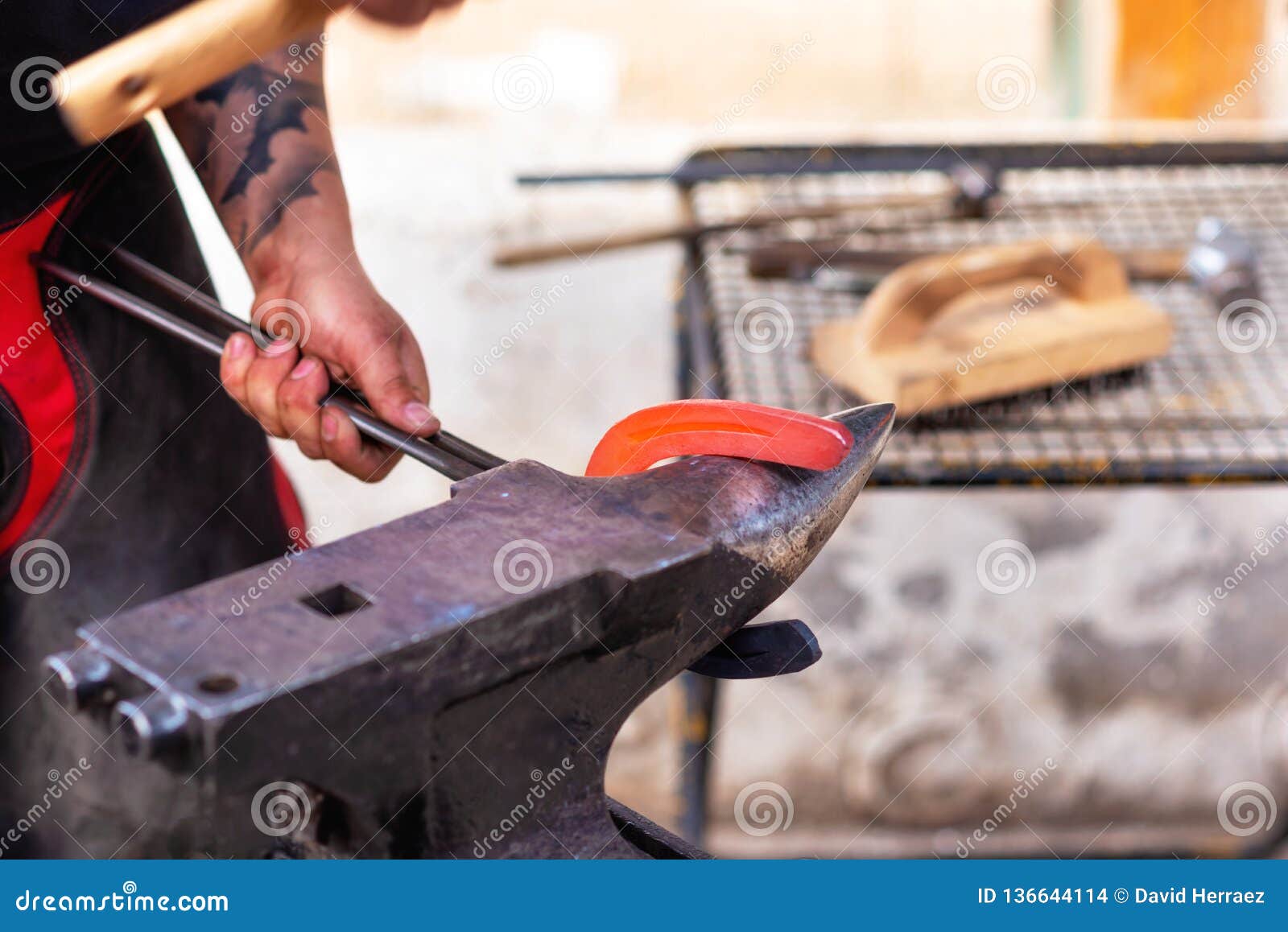 Blacksmith Working on the Anvil, Making a Horseshoe. Stock Photo