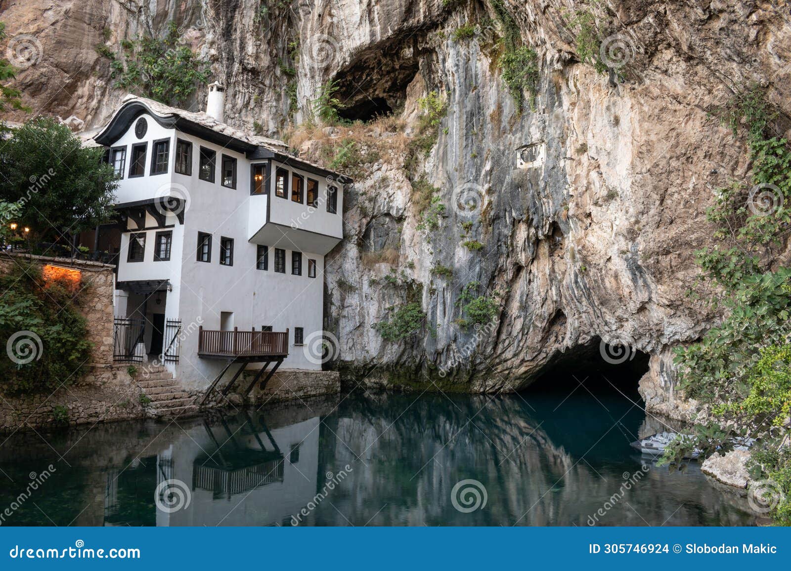 blagaj tekke and buna river source at foot of stone cliff