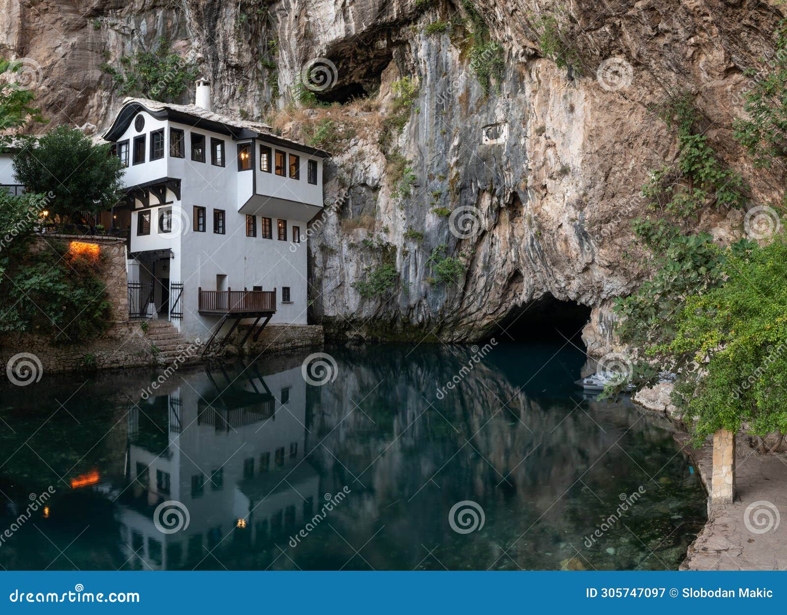 blagaj tekke and buna river source at foot of stone cliff
