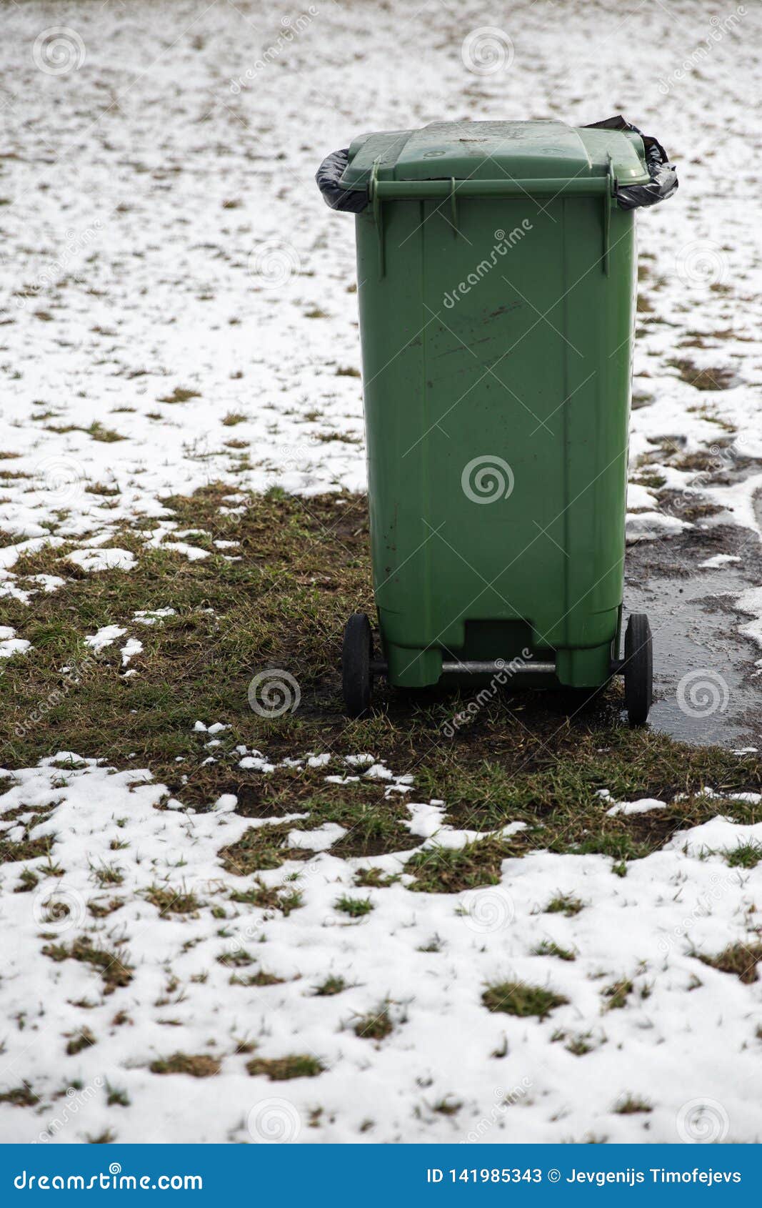blank ad space trash can standing in a picnic field in winter