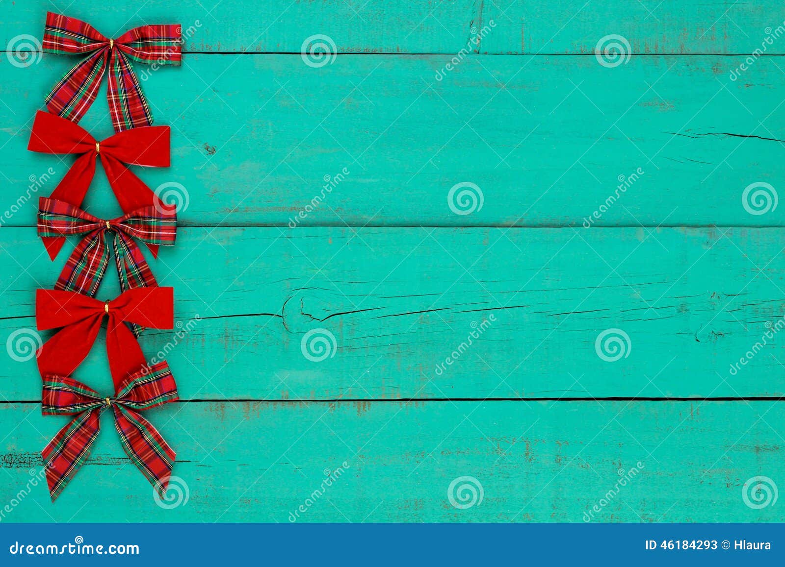 Blank antique green distressed wooden background with red plaid and velvet Christmas bow border