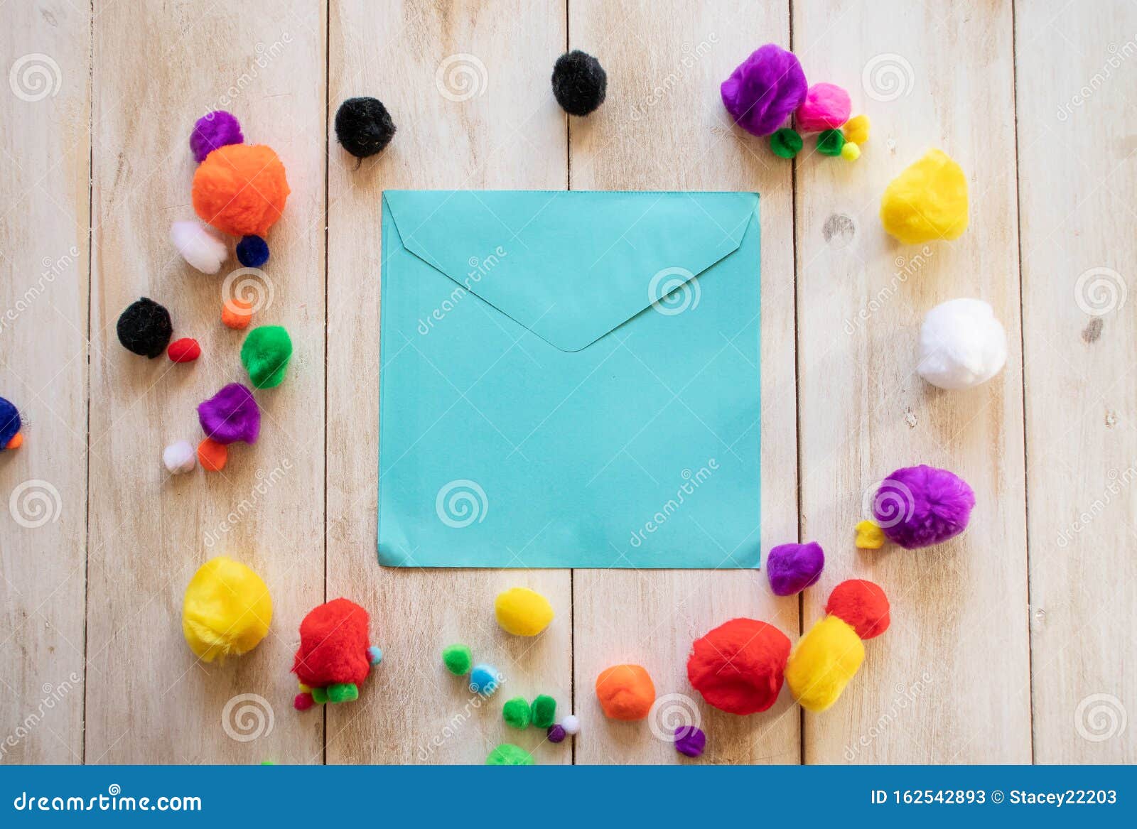Blank Blue Envelope Surrounded By Multi Coloured Pom Poms Stock Image Image Of Stylish Multicoloured