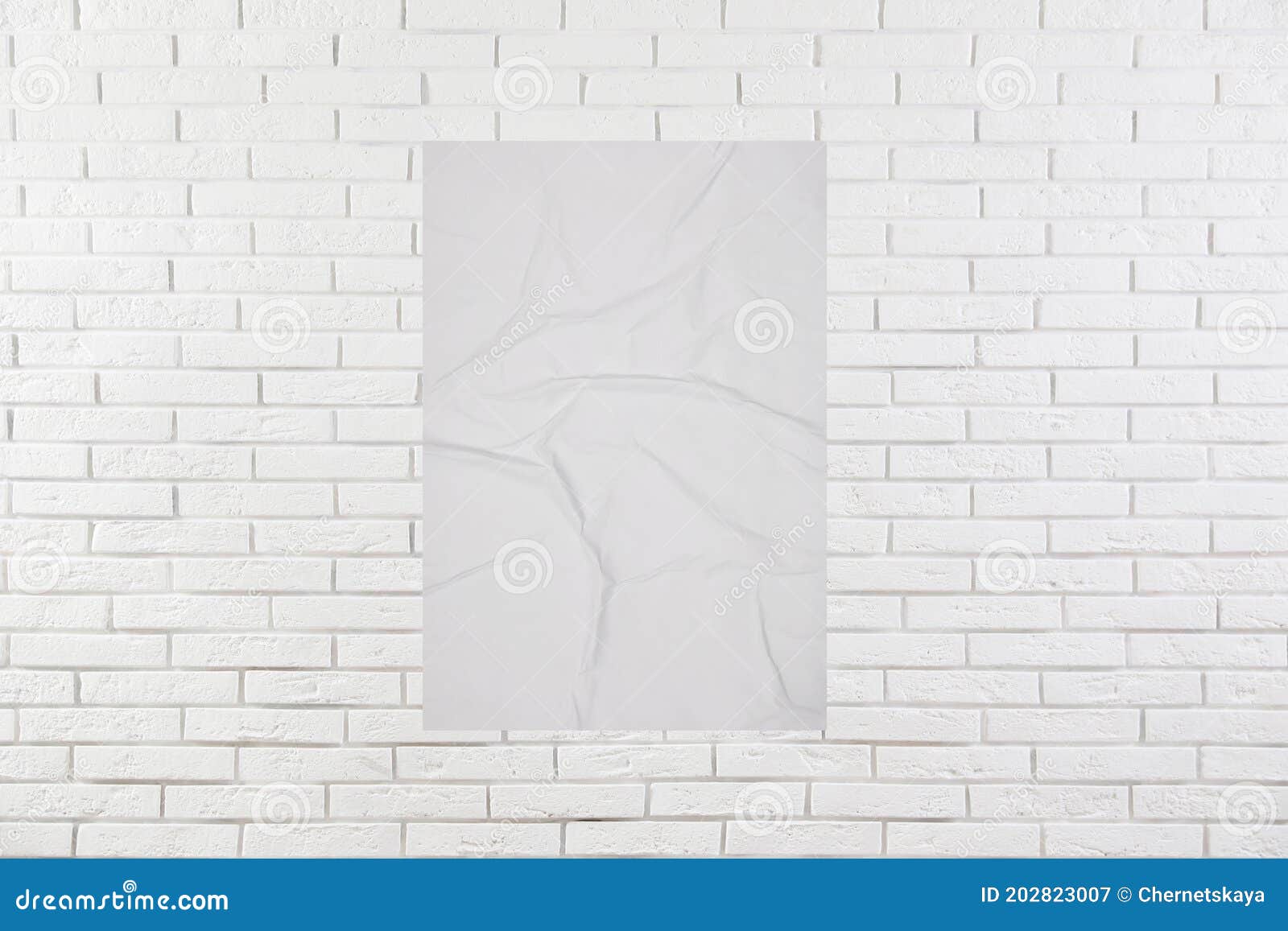 Blank Creased Poster on White Brick Wall. Mockup for Design Stock Image