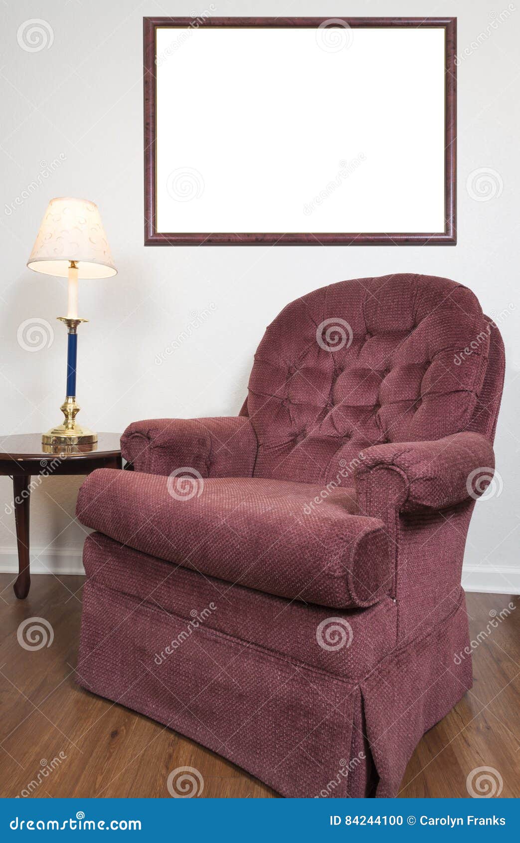 blank picture frame behind chair in home setting