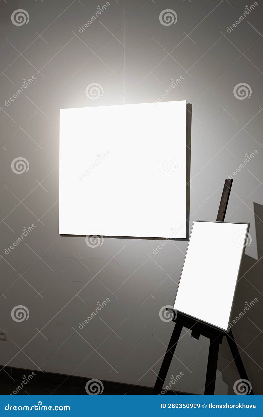 Blank Picture Frames on Grey Wall with Glowing Lamp, Mock Up Stock