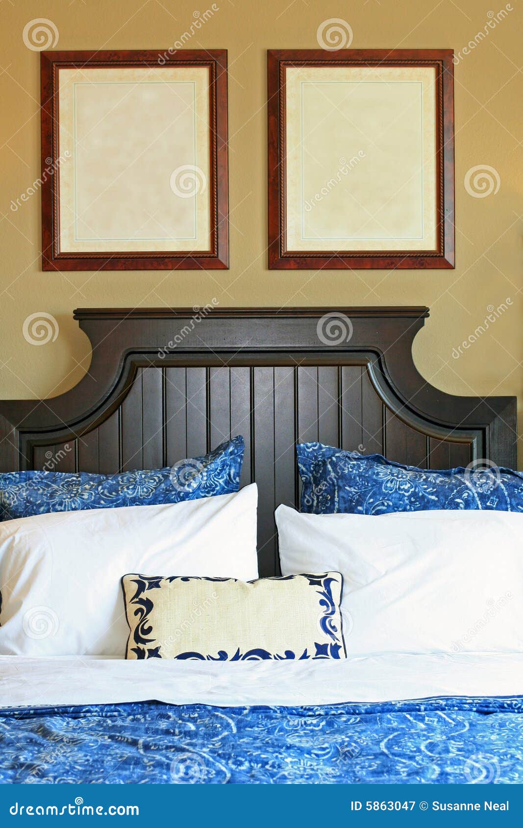 blank pictures on wall above bed