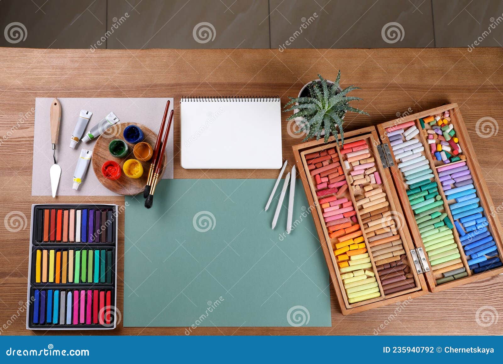 Soft pastels for artists and drawing paper on the wooden table