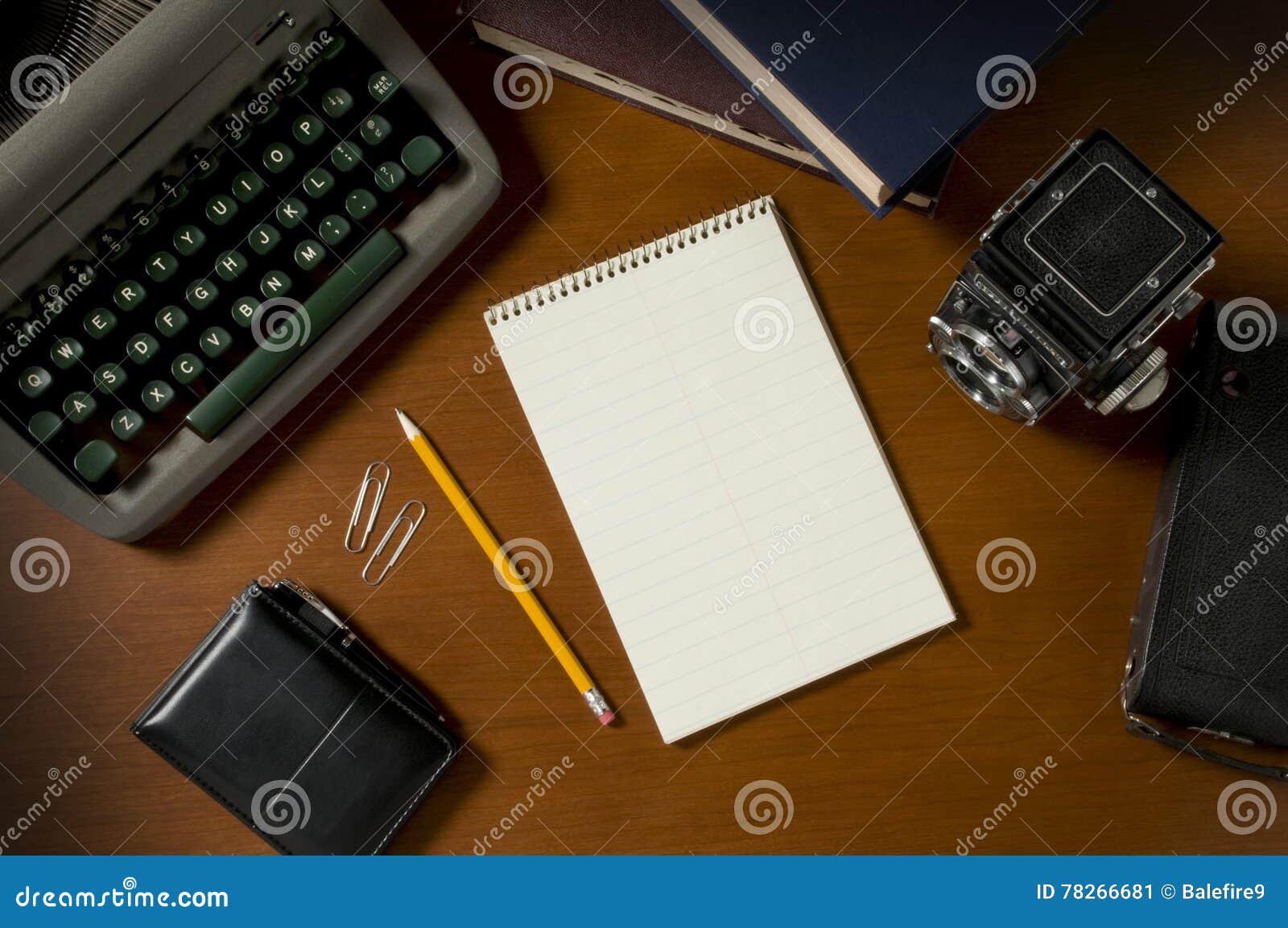 blank steno notepad on a desk among vintage journalism props