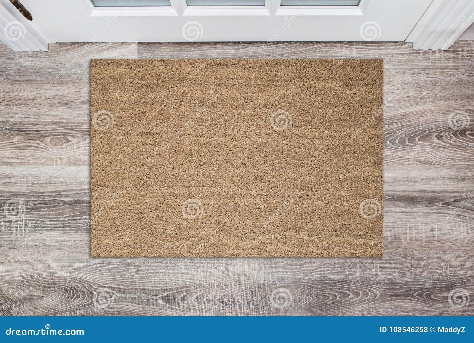 blank tan colored coir doormat before the white door in the hall. mat on wooden floor, product mockup