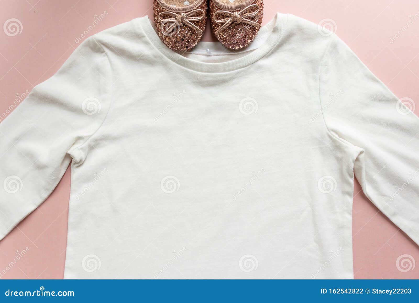 blank white toddler girl`s long sleeved t-shirt on pink background