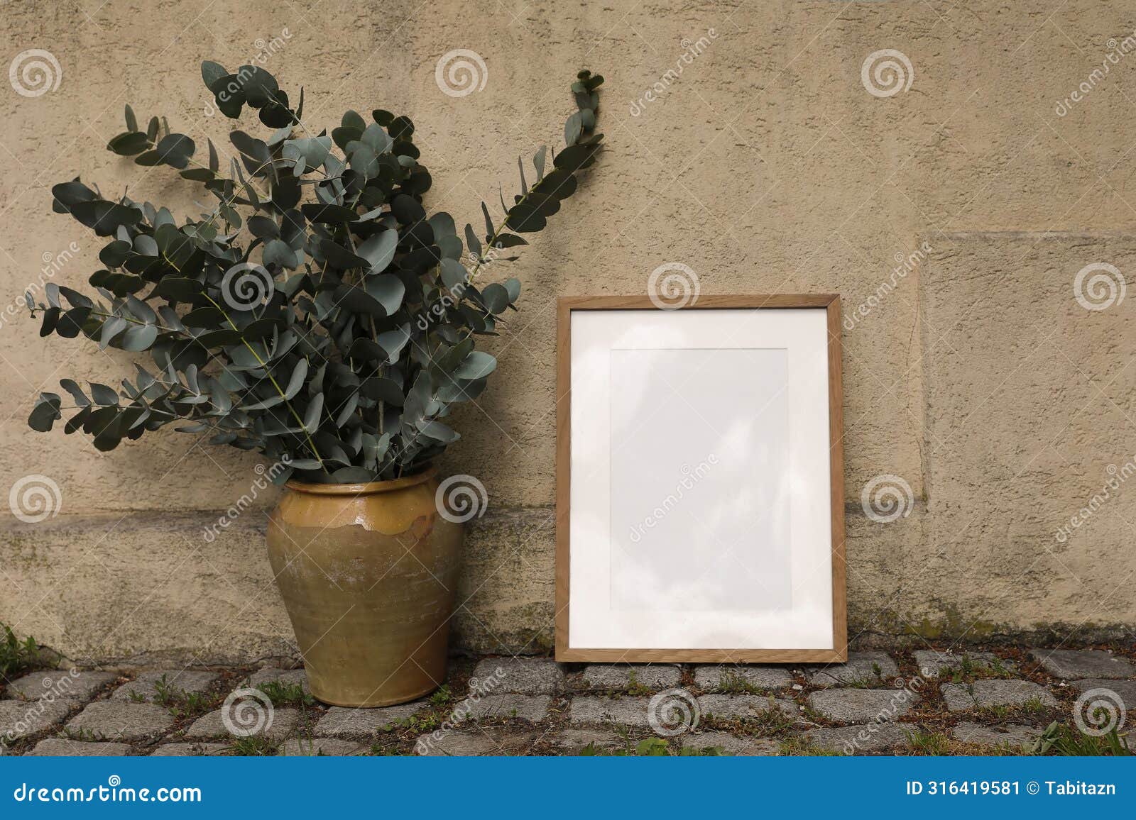 blank wooden picture frame mockup against old ochre textured white wall. a4, a3, a2 poster template. vintage vase, pot
