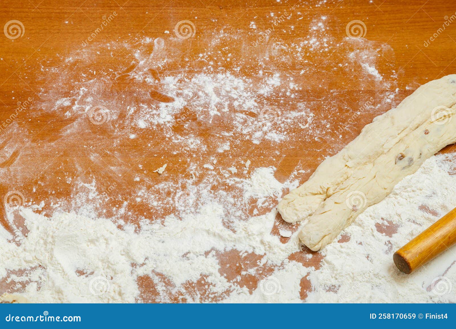 Blanks for Braided Bread on the Table among the Flour and Rolling Pin