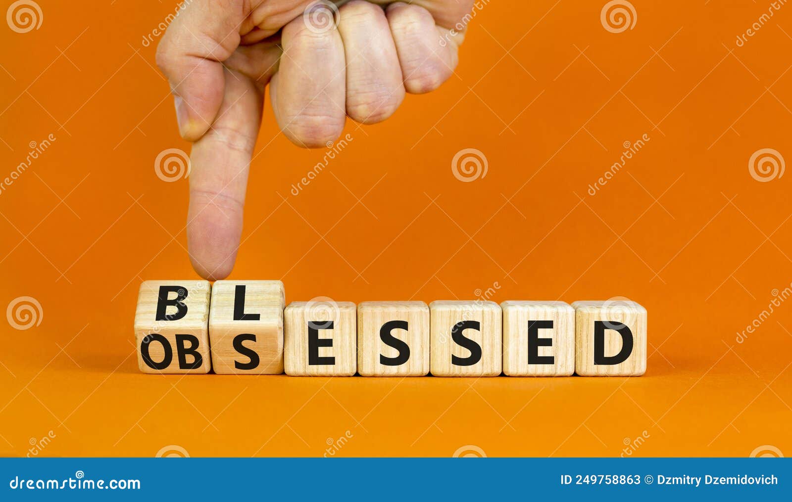 blessed or obsessed . businessman turns wooden cubes and changes the concept word obsessed to blessed. beautiful orange